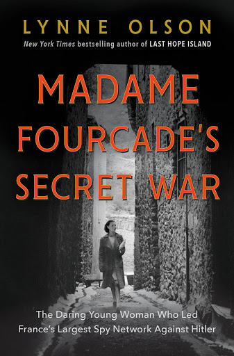 Black and white photo shows a young woman in an overcoat and high heels walking through a narrow alley, with stone walls to either side. TItle is in red above, and subtitle in white below. Subtitle read: The Daring Young Woman Who Lead France's Largest Spy Network Against Hitler.