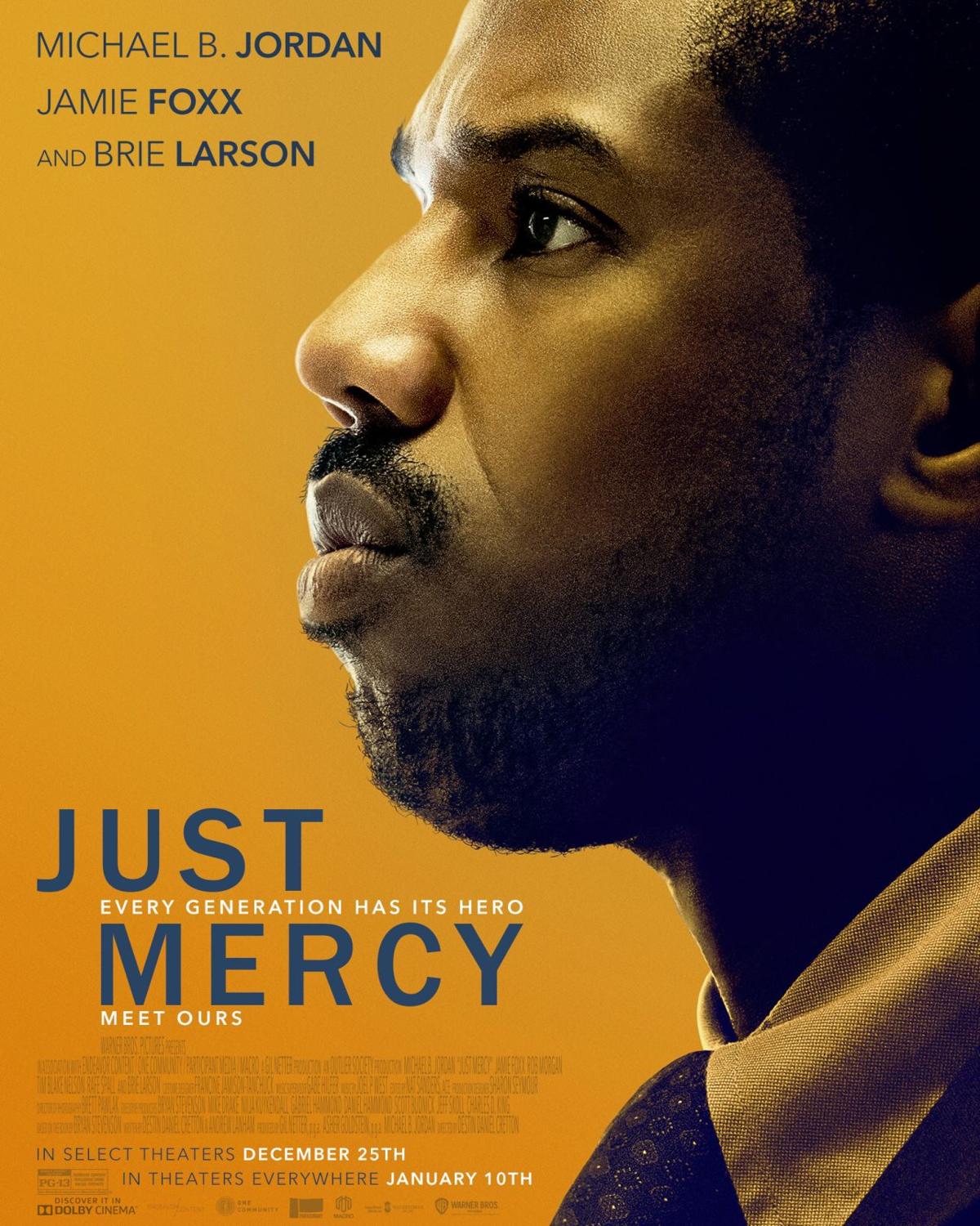 Michael B Jordan stands tall in a gray suit and blue shirt and tie, looking off into the distance.  Behind him, in muted yellow are scenes from the movie. Just Mercy is written in white, along with names of actors, Michael B Jordan, Jamie Foxx, and Brie Larson