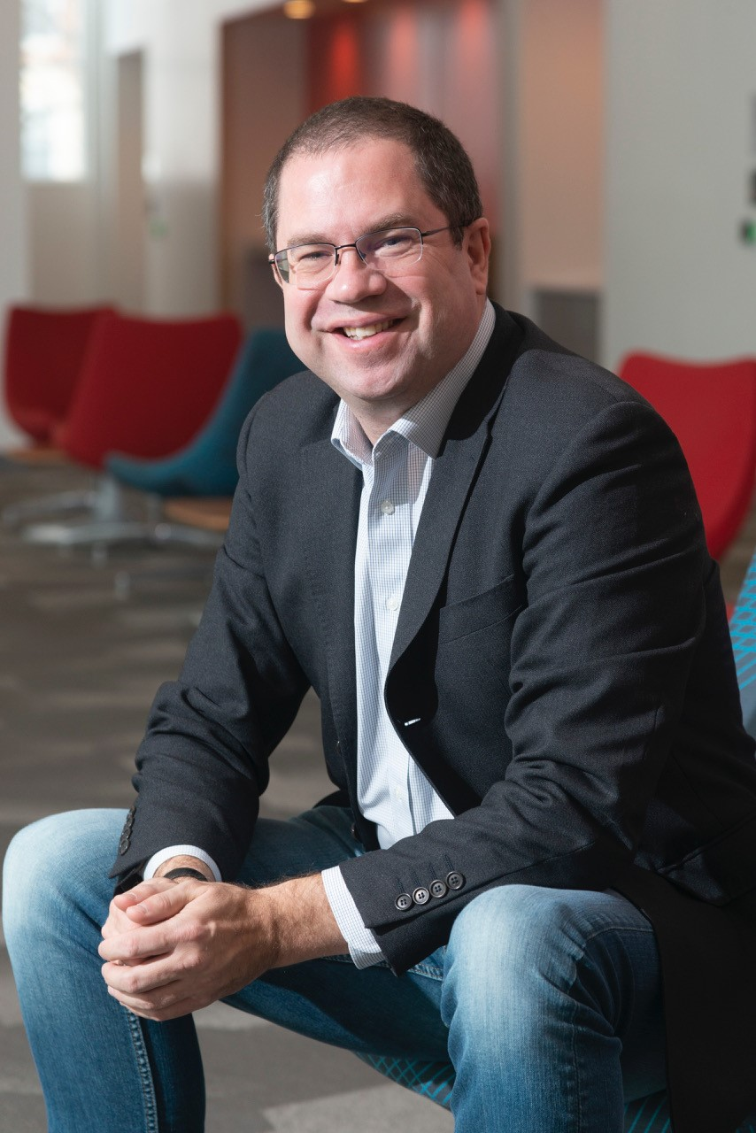 Antique paper background with black image of heroic figure pointing to the sky from on top of a star.