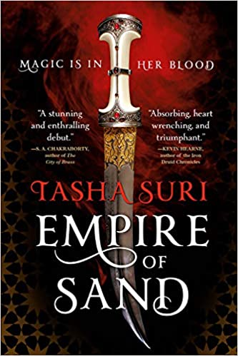 An ornate curved dagger with a jeweled hilt appears against a swirling red background, with "Magic is in her blood" at the top and Tasha Suri, Empire of Sand across it along the bottom.