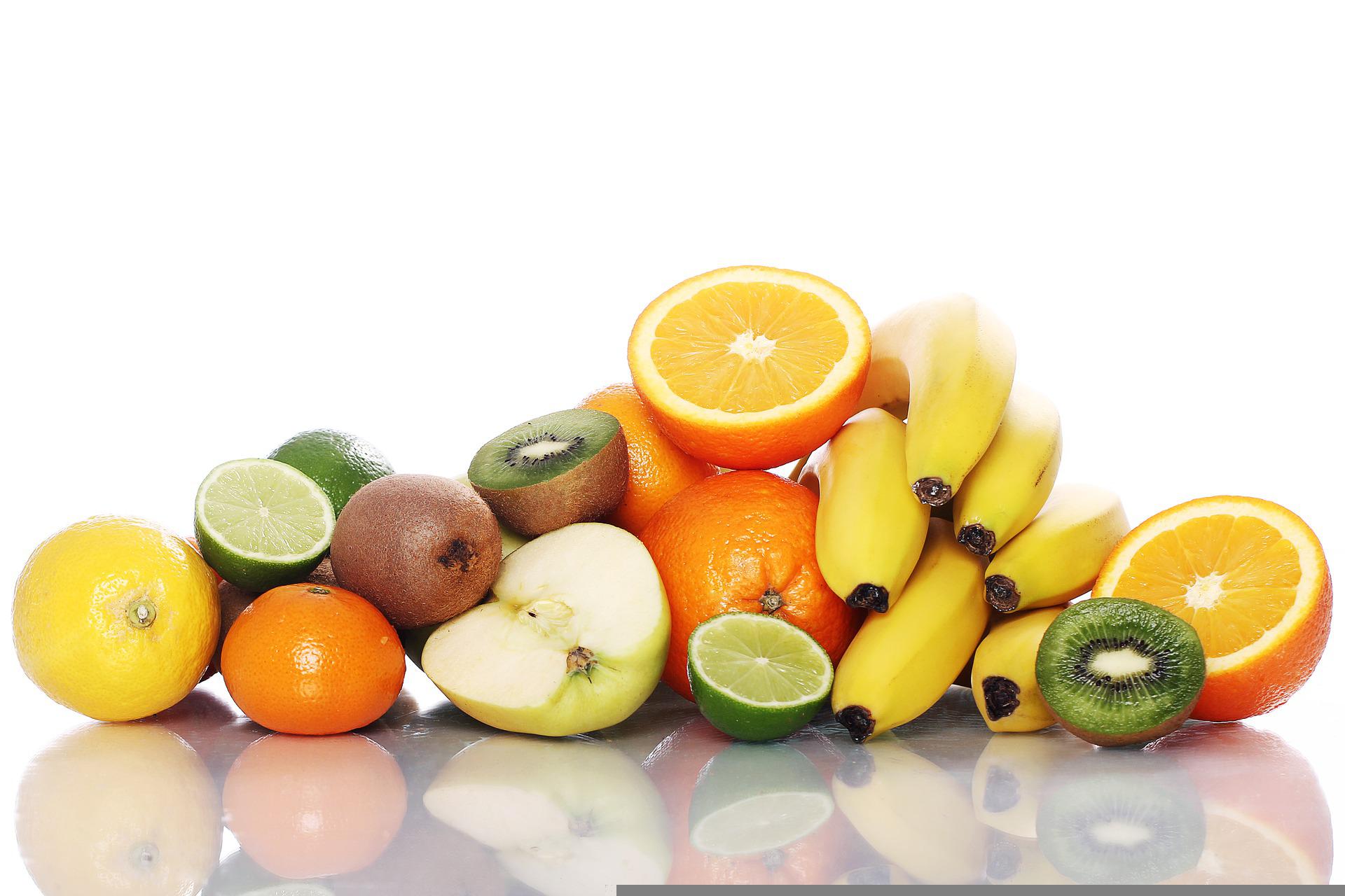 A pile of fruit including lemons, limes, tangerines, apples, kiwis, and a bananas.