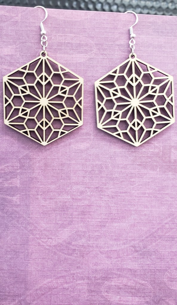 Two snowflake earrings made with the laser cutter.
