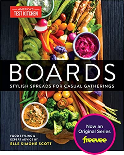The book cover is a photograph of a charcuterie board, with assorted vegetables including tomatoes, pepper strips, cucumber slices, broccoli florets, and halved radishes. There are also three small white bowls of assorted dips.