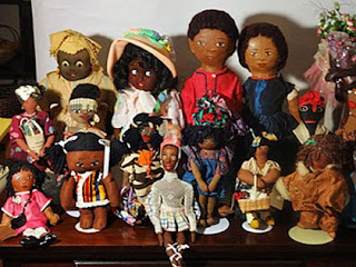 A selection of Black dolls in various styles and costumes.