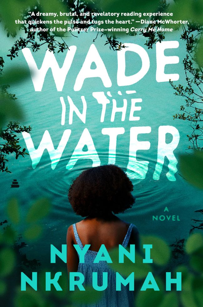 The viewer peers through leaves at a young Black girl standing at the edge of water where ripples circle.