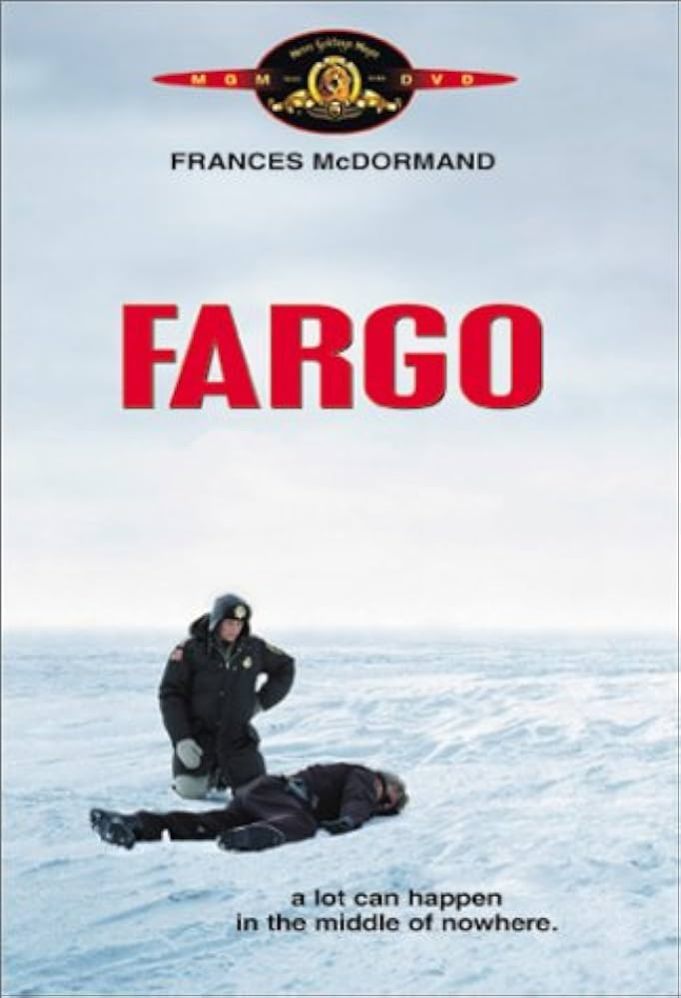 A police officer bundled in winter gear kneels in snow next to a face-down dead body. The scene is white sky over a field of snow. The title appears in red and teaser reads,"a lot can happen in the middle of nowhere."