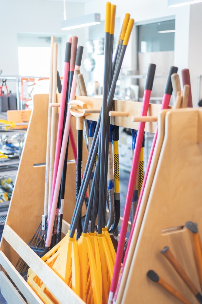 DIY Center at Elkridge branch with a container full of racks ant other yard care implements.