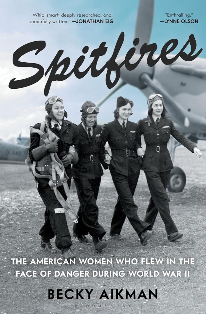The photograph shows four women aviators from the World War II era in uniform, several with flight gear and goggles, marching arm-in-arm in front of a propeller plane.